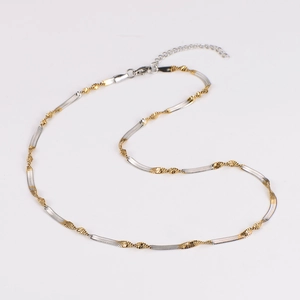 Close-up of two-tone twisted snake chain with lobster clasp and extension link