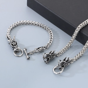 Detailed close-up of retro silver dragon head bracelet and necklace set for men