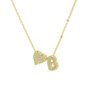 Macro detail of gold necklace with zircon pavé heart and letter B initial pendant