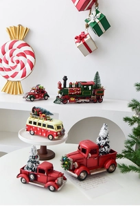 Close-up of vintage metal Christmas car models with mini trees and gift decorations