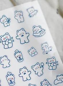 Détail de stickers d'ongles fins avec des ours bleus, motifs cœur et skateboard