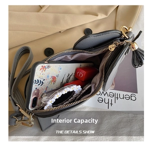 Macro view of interior storage space for phone and makeup in grey crossbody bag