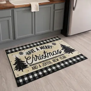 Detail of Christmas doormat with buffalo plaid border and festive tree on wood floor