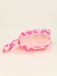 Detail view of pink cow print canvas makeup bag with zipper and handle strap