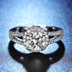 Macro shot of a brilliant round cut moissanite ring with halo and split-shank design
