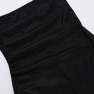 Close-up detail of black sparkly fabric with elegant ruched design and sequins