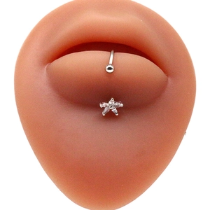 Silver stainless steel lip ring with a floral pendant and clear crystal inlays