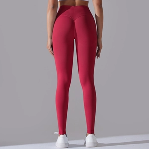 Detail view of red seamless yoga leggings with a V-shaped waist for peach butt lifting effect