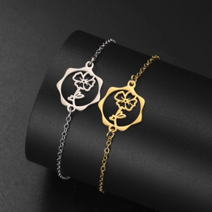 Detailed view of gold and silver birth flower bracelets with hollow hexagon charms