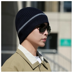 Close-up of a men's navy blue ribbed knit beanie with grey stripes for outdoor winter warmth
