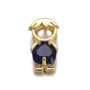 Detailed close-up of a gold boy charm with deep blue heart zircon for DIY jewelry