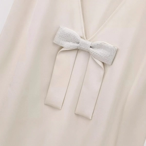 Elegant off-white V-neck dress featuring a sparkling rhinestone bow detail for women
