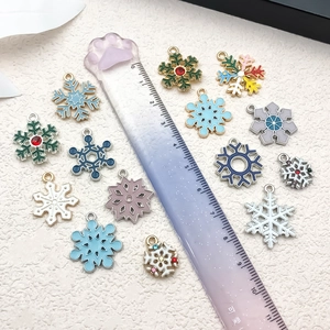 Macro view of colorful snowflake charms with enamel inlay and sparkling rhinestones