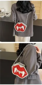 Detailed view of red sequin vampire lips crossbody bag with silver chain strap and zipper