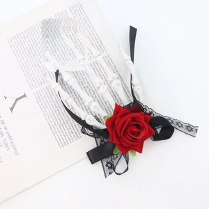 Halloween skeleton hand hair clip with red rose and black lace on vintage book background