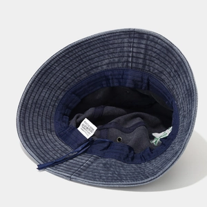 Navy blue washed cotton bucket hat with interior lining detail and chin strap cord