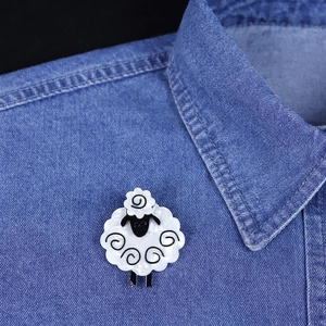 Cute black and white sheep acrylic brooch pinned on a denim shirt collar for fashion