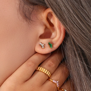 Close-up of gold plated stainless steel flower stud earrings with marquise cut zircon