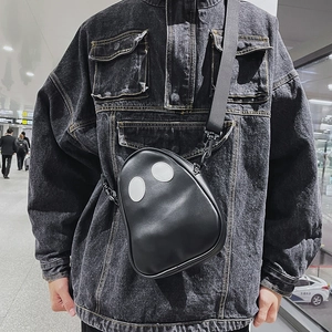 Detailed view of black ghost-shaped PU leather crossbody bag with white eye appliques