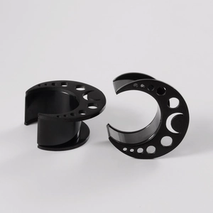 Pair of black stainless steel crescent moon ear gauges with hollow circular cutouts