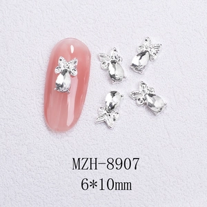 Macro view of silver bow nail charm with teardrop crystal and 6x10mm size detail