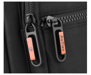 Detailed close-up of premium black nylon fabric and branded metal dual zippers