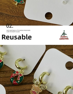 Close-up of festive Christmas earrings featuring colorful enamel elk and wreath designs