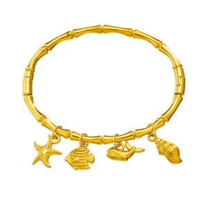 Gold bamboo-style stainless steel bangle featuring starfish and tropical fish sea charms