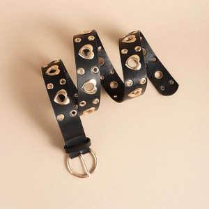 Detail of black PU leather belt with gold heart eyelets and round pin buckle