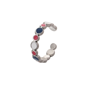 Detail of vintage silver open ring with colorful enamel inlay and brushed metal texture
