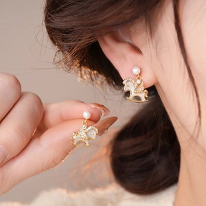 Chic 18k gold plated rocking horse earrings with pearls and crystals on female model