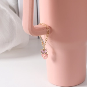 Pink enamel heart charm with letter A and butterfly on a golden Stanley cup chain