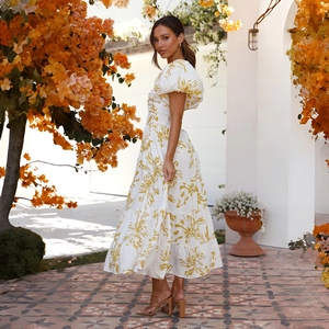Close-up of elegant puff sleeves and floral print on white summer maxi dress
