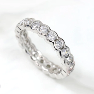 Elegant geometric pavé eternity ring in silver finish on a marble background surface