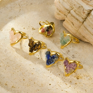 Set of six heart-shaped 18K gold plated rings with natural gemstone inlay on stone tray
