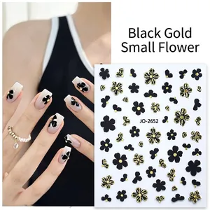 Minimalist black and gold flower nail stickers with floral and bow designs for manicure