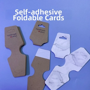 Macro shot of self-adhesive folding jewelry cards in kraft paper and marble patterns