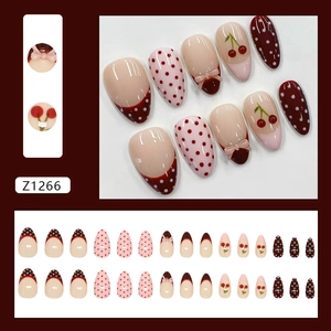 Pink French dot press-on nails with 3D bows and cherry patterns in round oval shape