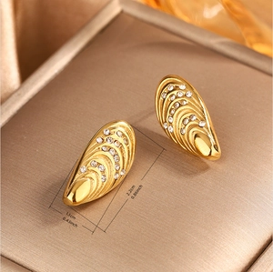 Detailed view of gold irregular stud earrings with white stones and size dimensions