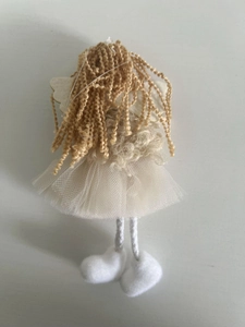 Back view of handmade angel ornament with golden curls and white mesh skirt