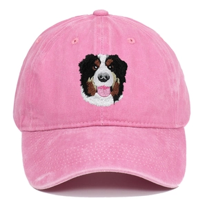 Close-up of Bernese Mountain Dog embroidery on a vintage pink washed cotton baseball cap