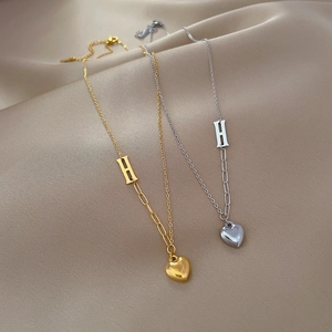 Minimalist titanium steel gold and silver H-letter heart necklaces set on silk fabric
