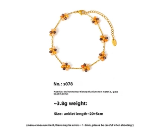 Detail of bohemian floral anklet with orange glass beads and titanium steel chain