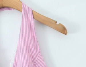 Close-up of pink and white striped halter dress with delicate white lace trim on the collar