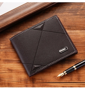 Close-up of deep brown leather wallet with geometric embossing and business accessories