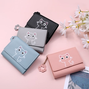 Close-up of textured PU leather wallets with cute cat prints and cat paw metal charms