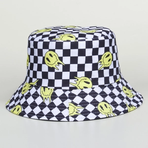 Close-up of checkered bucket hat featuring yellow melting smiley faces on canvas fabric