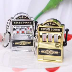 Close-up of mini gold and silver lucky slot machine keychains with movable levers