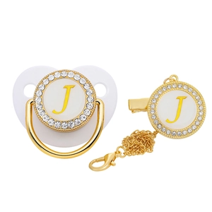Detailed view of white baby pacifier and clip set with gold rhinestones and letter J