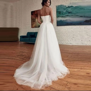 Elegant strapless white A-line wedding dress with a long train and button back detail